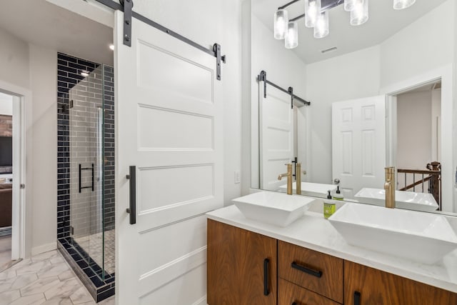 bathroom featuring visible vents, marble finish floor, a stall shower, a sink, and double vanity