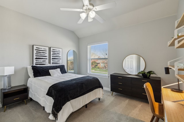 bedroom featuring vaulted ceiling, light colored carpet, baseboards, and ceiling fan