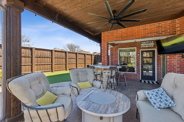 view of patio featuring a ceiling fan, an outdoor living space, and fence