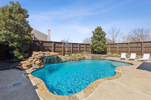 view of pool featuring a fenced in pool, an in ground hot tub, a fenced backyard, and a patio area