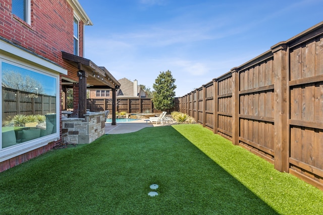 view of yard with a patio area, a fenced in pool, and a fenced backyard