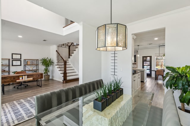 dining room featuring baseboards, stairway, ornamental molding, recessed lighting, and wood finished floors