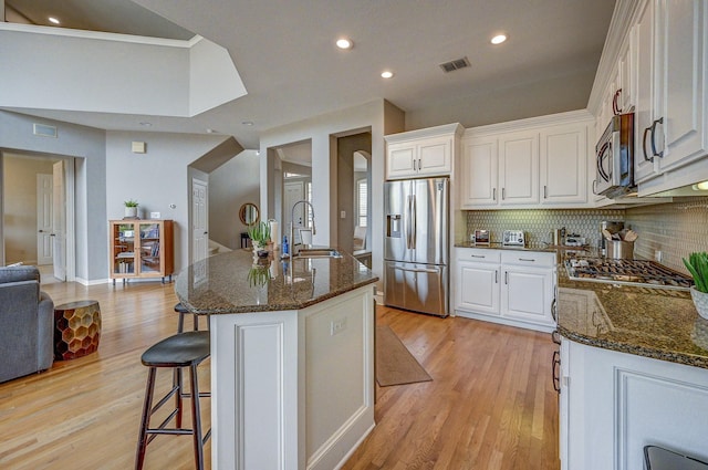 kitchen featuring white cabinetry, visible vents, appliances with stainless steel finishes, and a sink