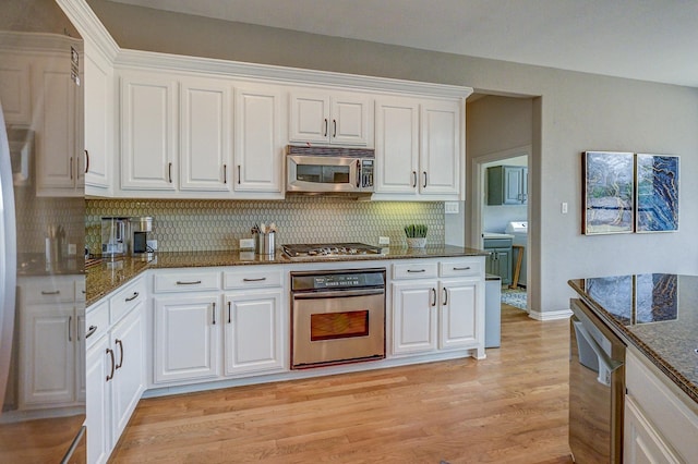 kitchen featuring white cabinetry, light wood-style flooring, and appliances with stainless steel finishes