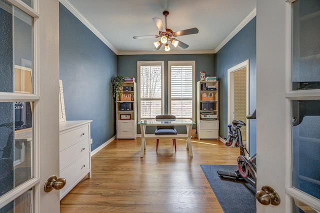 home office with light wood-style flooring, ornamental molding, baseboards, and ceiling fan