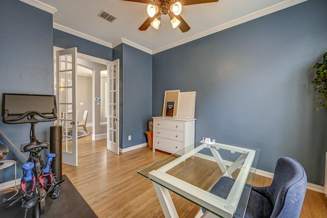 home office featuring baseboards, visible vents, light wood-style flooring, ceiling fan, and french doors