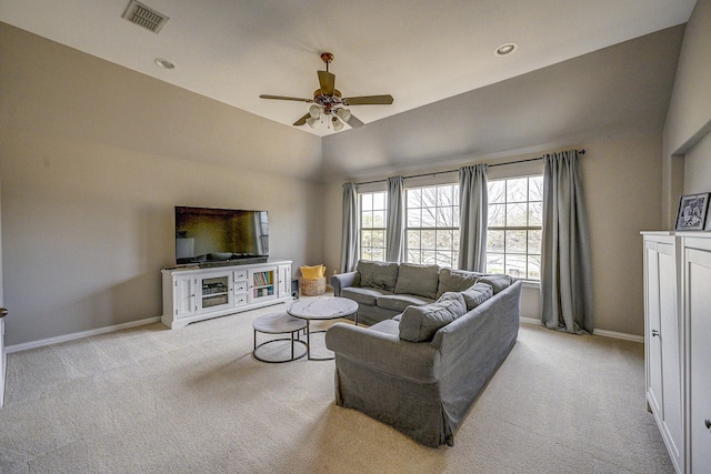 living area with visible vents, light carpet, baseboards, and ceiling fan