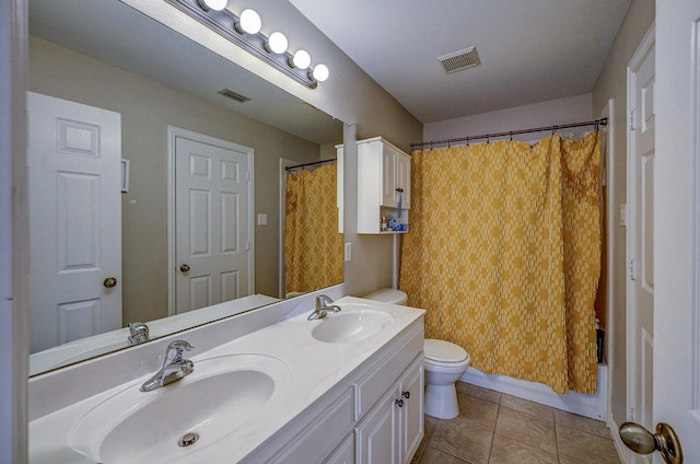 bathroom with tile patterned flooring, toilet, visible vents, and a sink