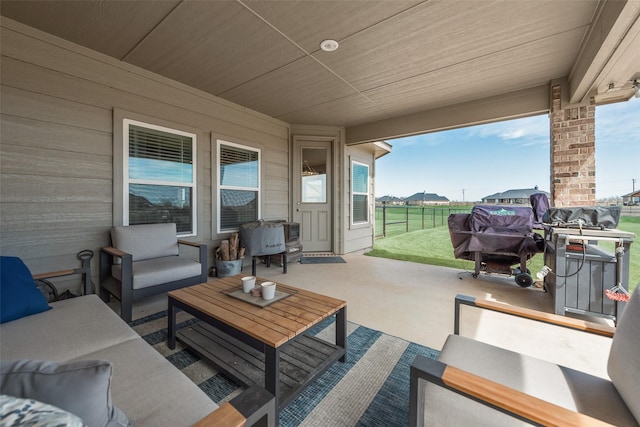 view of patio featuring an outdoor living space and fence