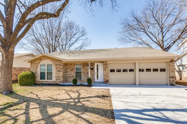 single story home with brick siding, an attached garage, driveway, and roof with shingles