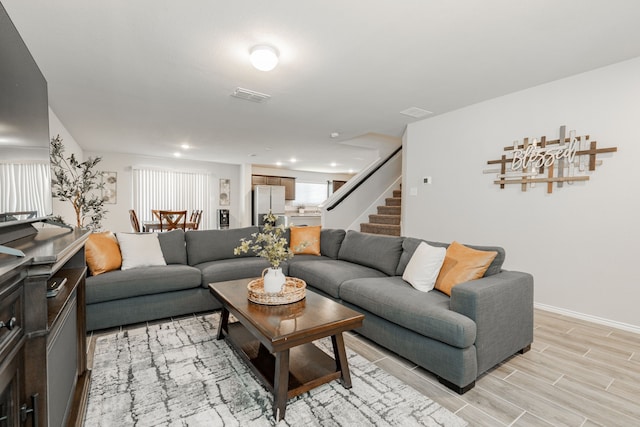 living area featuring wood finish floors, visible vents, recessed lighting, stairway, and baseboards