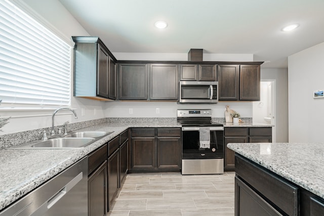 kitchen with a sink, dark brown cabinetry, recessed lighting, and stainless steel appliances