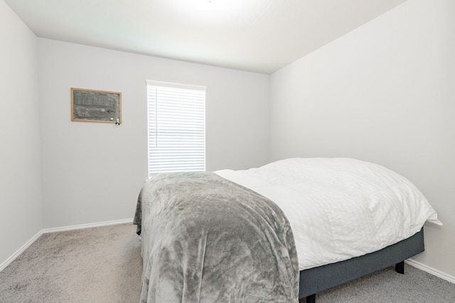 bedroom with carpet flooring and baseboards