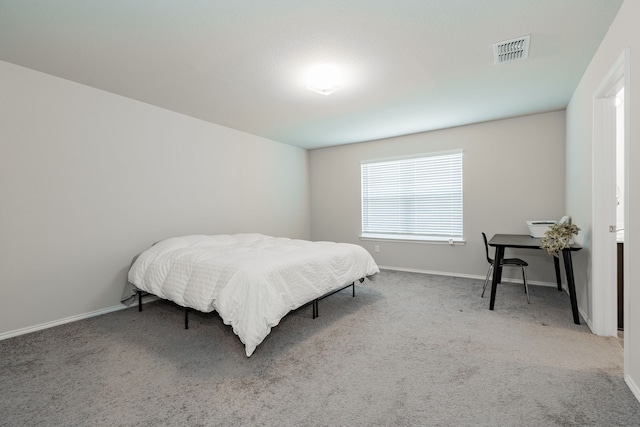 carpeted bedroom with baseboards and visible vents