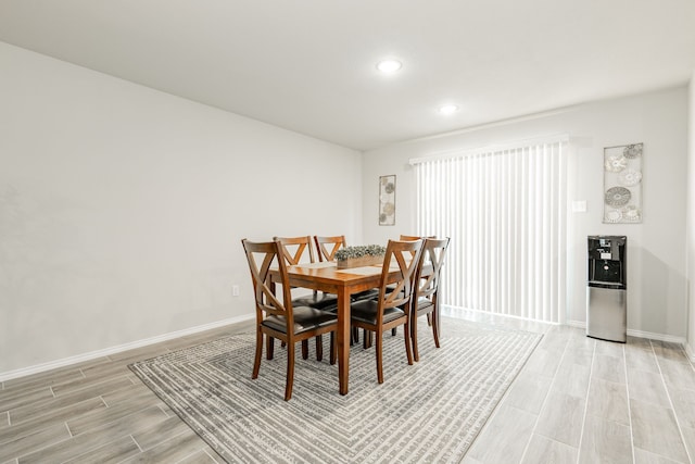 dining area featuring recessed lighting, baseboards, and wood tiled floor