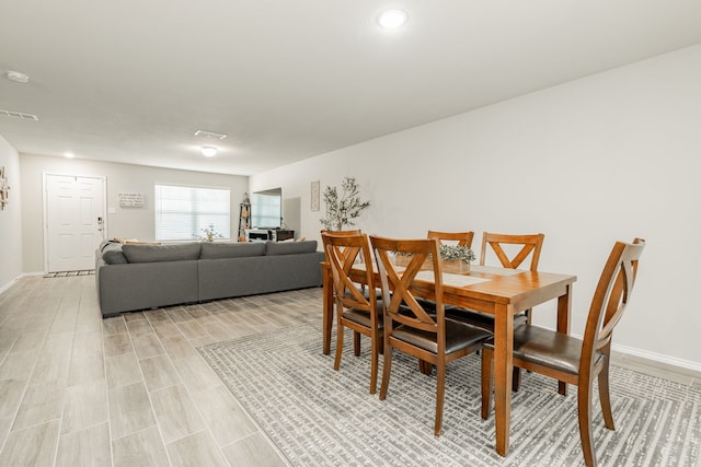 dining area featuring visible vents, baseboards, and light wood-style flooring