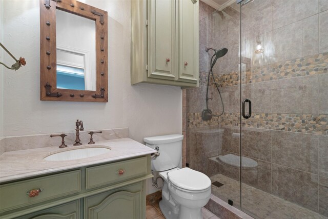 bathroom featuring vanity, toilet, and a stall shower