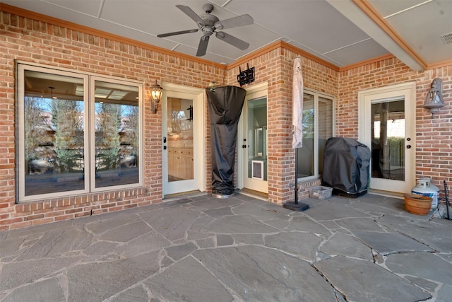 view of patio featuring visible vents, a grill, and a ceiling fan