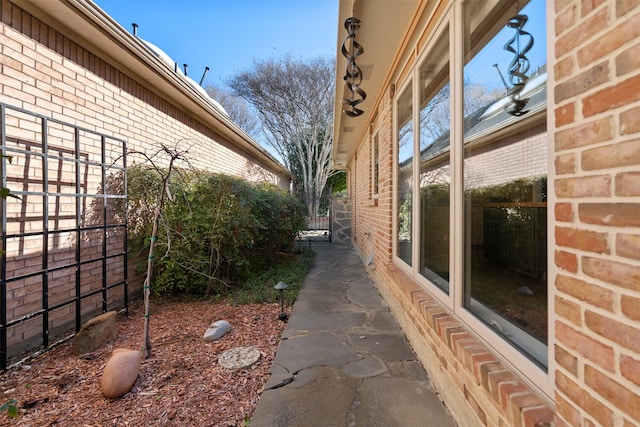 view of side of property featuring brick siding