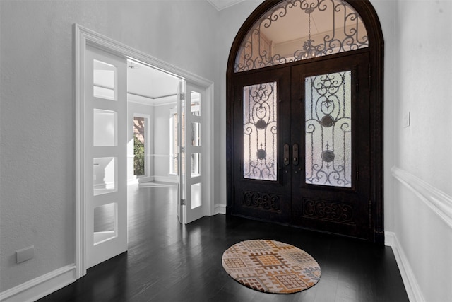 foyer entrance with french doors, baseboards, and dark wood-style flooring