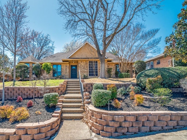 single story home featuring brick siding