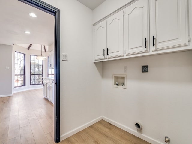 laundry room featuring light wood finished floors, baseboards, washer hookup, cabinet space, and hookup for an electric dryer