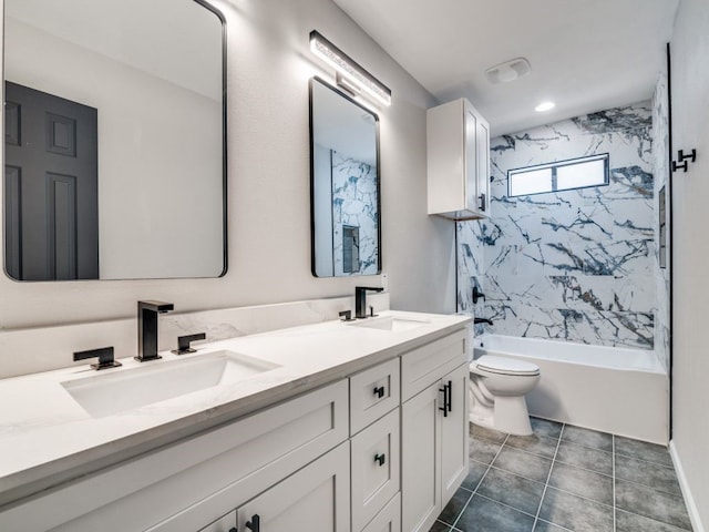 full bath with double vanity, tile patterned floors, toilet, and a sink