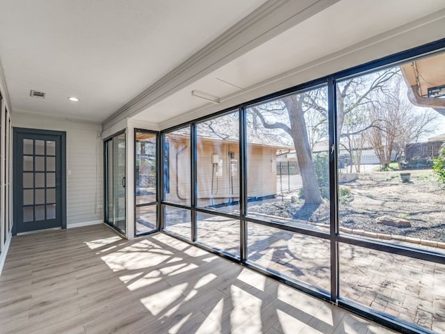 unfurnished sunroom featuring visible vents