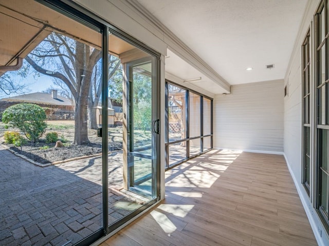 unfurnished sunroom featuring visible vents