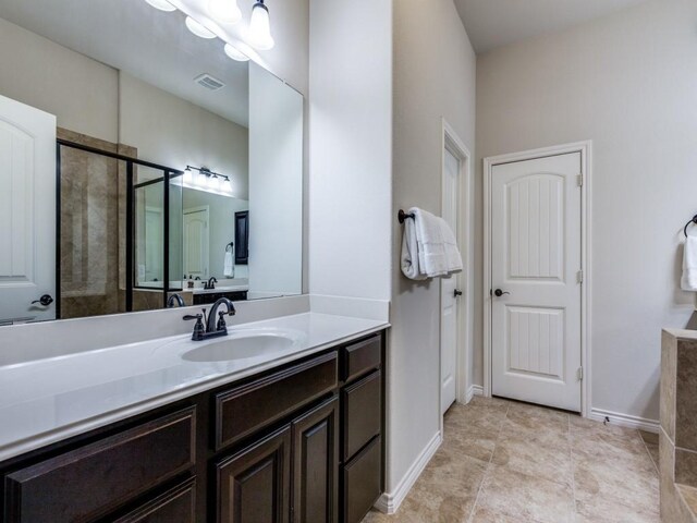 bathroom with vanity, baseboards, visible vents, tile patterned flooring, and an enclosed shower