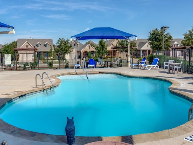 pool featuring a patio area and fence