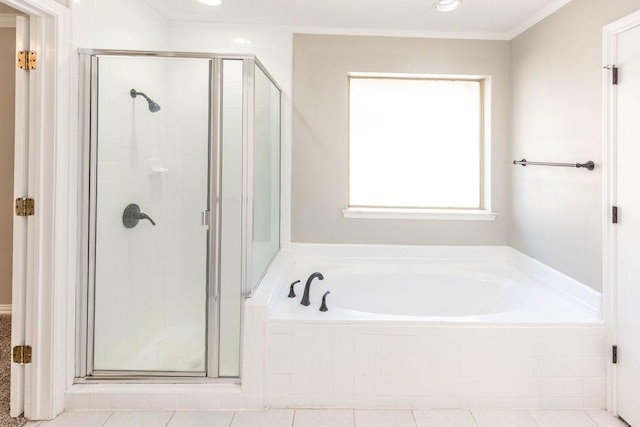 bathroom with tile patterned floors, a shower stall, a garden tub, and ornamental molding