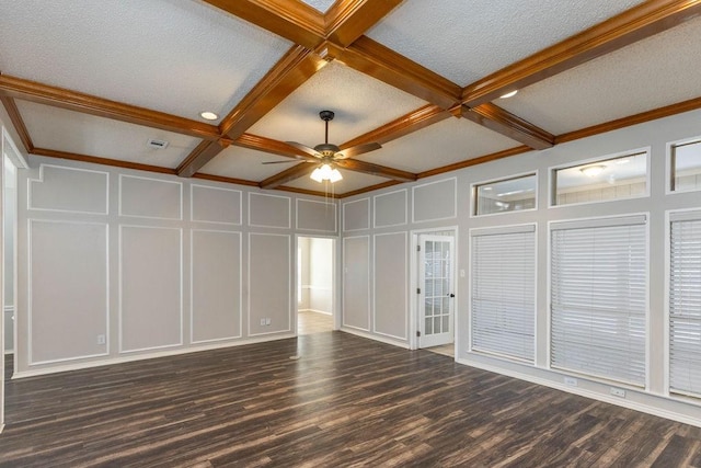 empty room featuring beam ceiling, wood finished floors, a decorative wall, coffered ceiling, and a textured ceiling