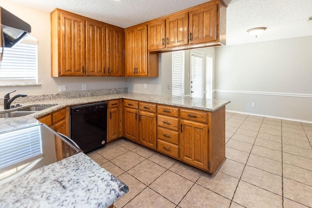 kitchen featuring dishwasher, light tile patterned floors, a peninsula, a textured ceiling, and a sink