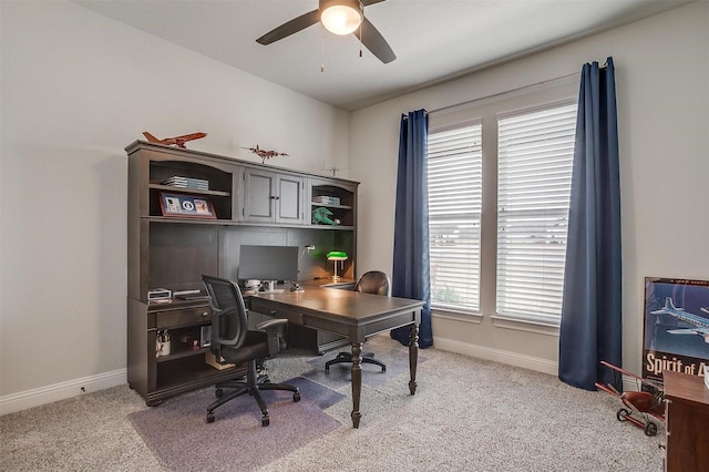 office area with light colored carpet, a ceiling fan, and baseboards