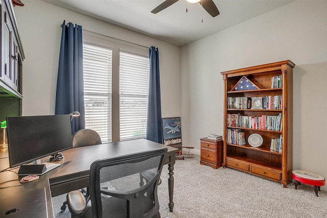 office with ceiling fan, baseboards, and light carpet