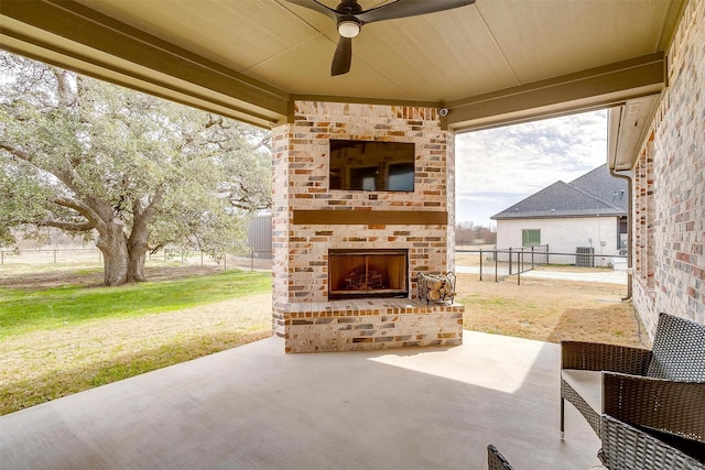 view of patio featuring ceiling fan, central AC, an outdoor brick fireplace, and fence