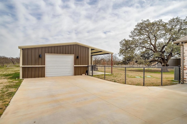 garage featuring fence and a garage