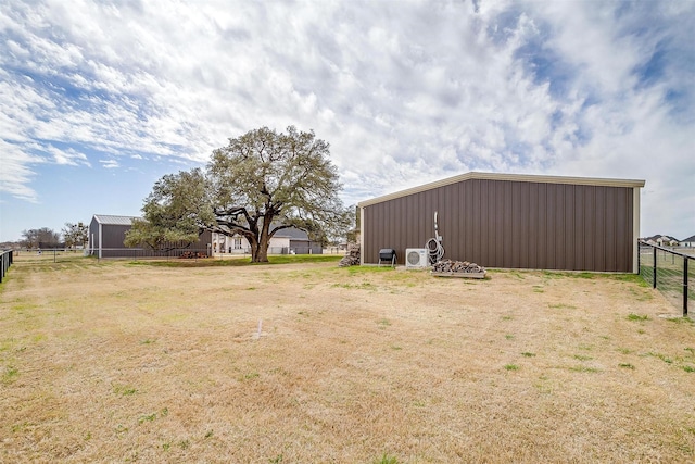 view of yard featuring an outbuilding and fence