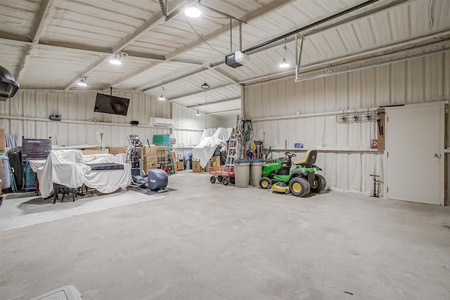 garage with a garage door opener and metal wall