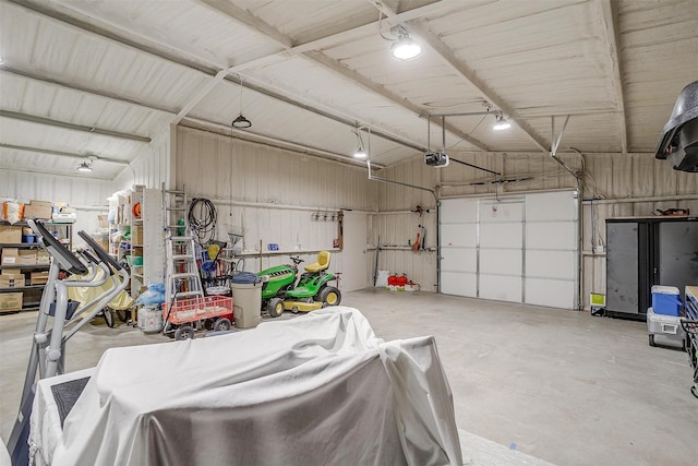 garage with a garage door opener and metal wall