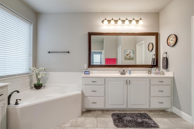 bathroom with a bath, tile patterned flooring, vanity, and baseboards