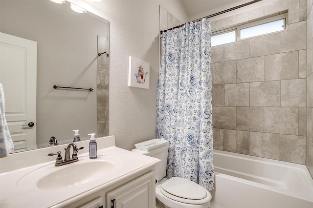 full bath featuring a textured wall, toilet, vanity, and shower / bath combination with curtain