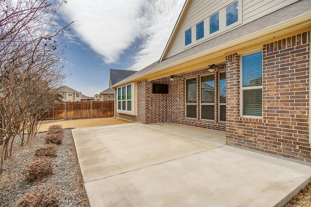 view of patio featuring ceiling fan and fence