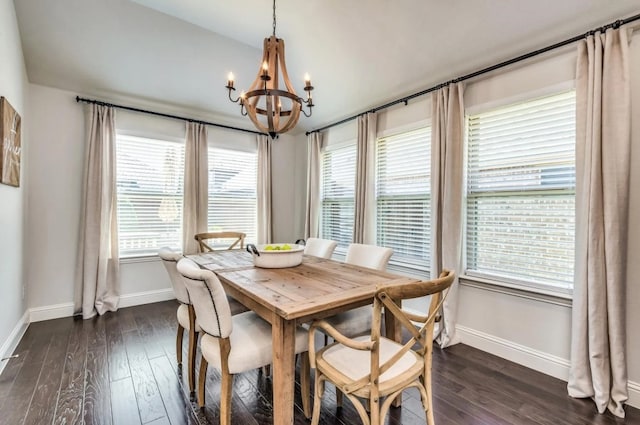 dining area with dark wood-style floors, a notable chandelier, and baseboards