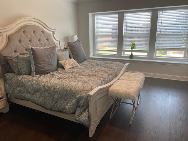 bedroom with baseboards and dark wood-style floors