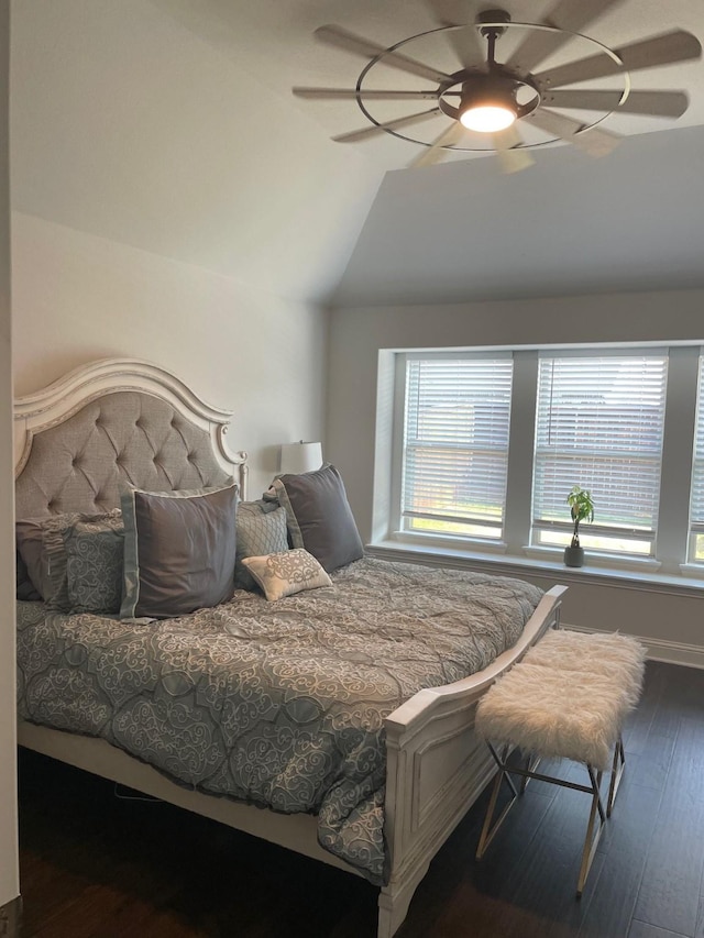 bedroom with a ceiling fan, lofted ceiling, and wood finished floors