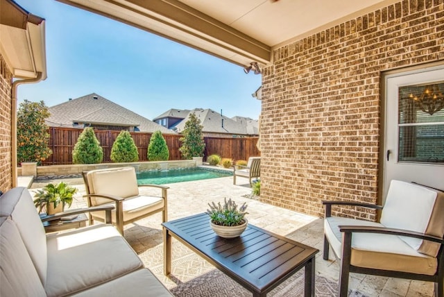 view of patio / terrace with an outdoor living space, a fenced backyard, and a fenced in pool