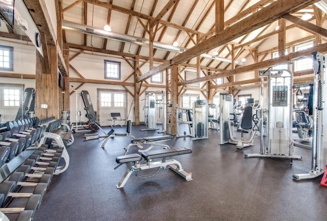 exercise room with high vaulted ceiling