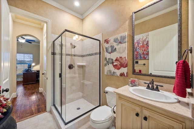 full bath with tile patterned floors, a shower stall, toilet, and ornamental molding